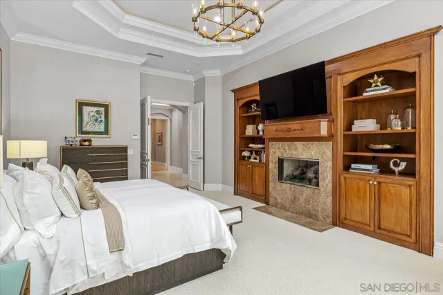 a spacious bedroom with a bed a couch and large window