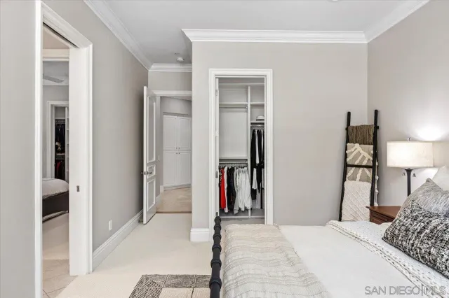 a spacious bedroom with a bed and a chandelier