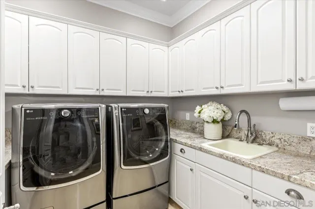 a bathroom with a granite countertop double vanity and a shower