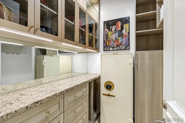 a living room with furniture a flat screen tv and floor to ceiling window
