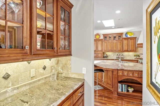 a kitchen with stainless steel appliances granite countertop a sink and a stove