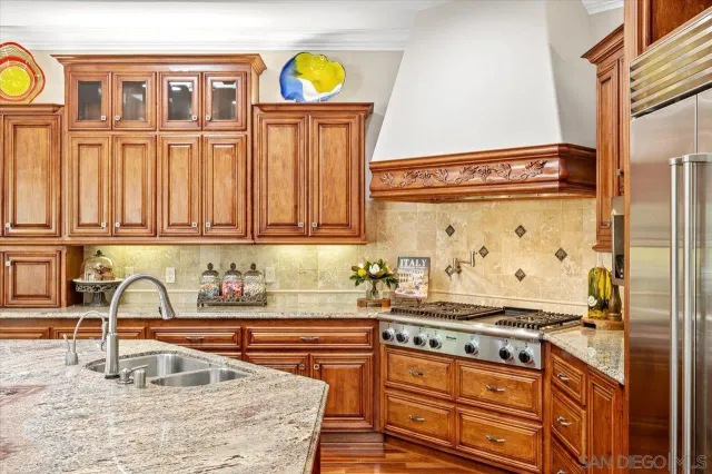 a kitchen with stainless steel appliances granite countertop a sink and a counter space