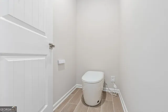 a white toilet sitting next to a white sink