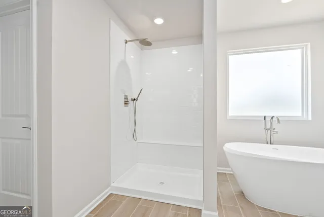 a bathroom with a bathtub and a shower