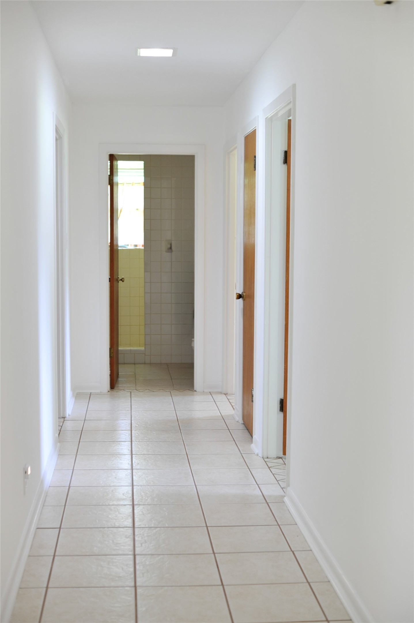 402 Peach Point Road Jones Creek, TX 77541 - Photo 19 of 32 Fresh paint in the hallway leading to hall bath and bedrooms