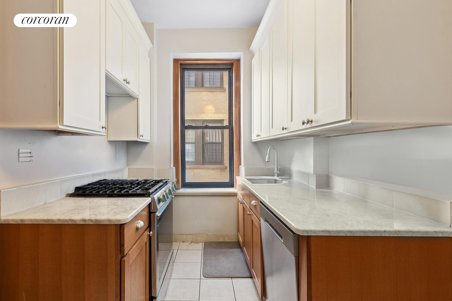 790 Riverside Drive, Unit 7C Manhattan, NY 10032 - Photo 3 of 12 a kitchen with stainless steel appliances granite countertop a sink stove and cabinets