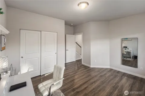 a view of a livingroom with wooden floor and a couch