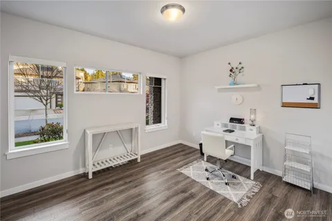 a workspace with furniture hardwood and a window