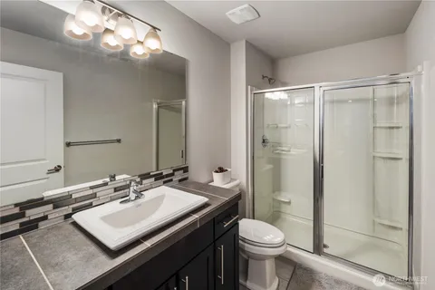 a bathroom with a sink toilet and shower