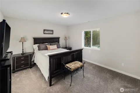 a bedroom with a bed and a dresser