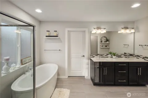 a spacious bathroom with a granite countertop sink and a mirror