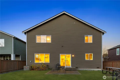 a view of a house with backyard and porch