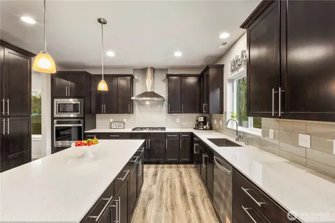 a very nice looking kitchen with a large counter top appliances and cabinets