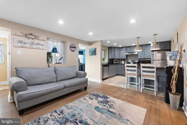 a view of a living room kitchen and a wooden floor