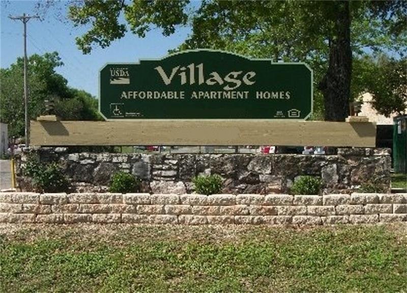 1410 Naples Street Castroville, TX 78009 - Photo 2 of 6 a sign that is on the side of the road