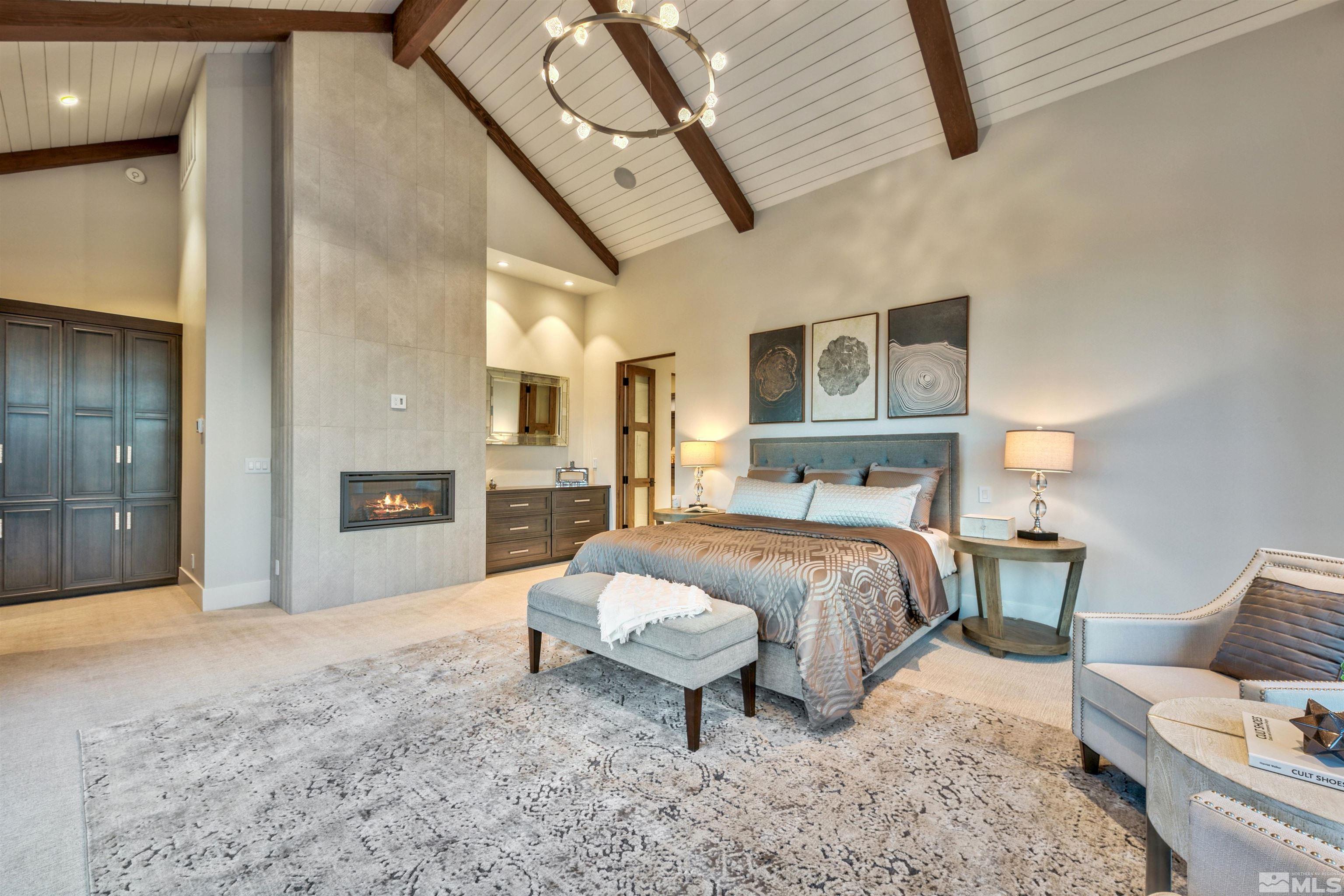 170 Hawken Road Reno, NV 89519 - Photo 12 of 26 a spacious bedroom with a bed a couch and dresser