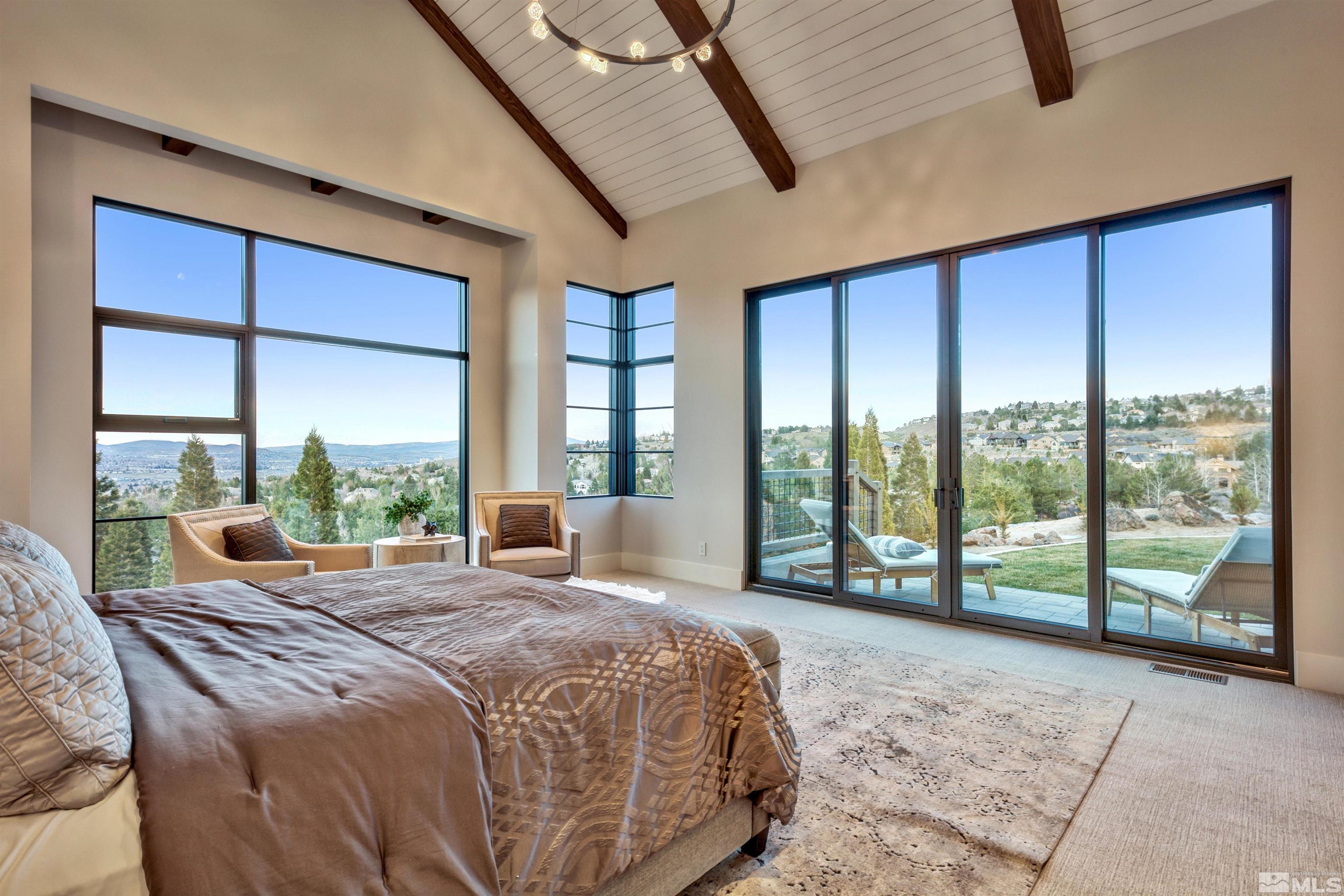 170 Hawken Road Reno, NV 89519 - Photo 13 of 26 a large bedroom with a bed and glass walk in closet