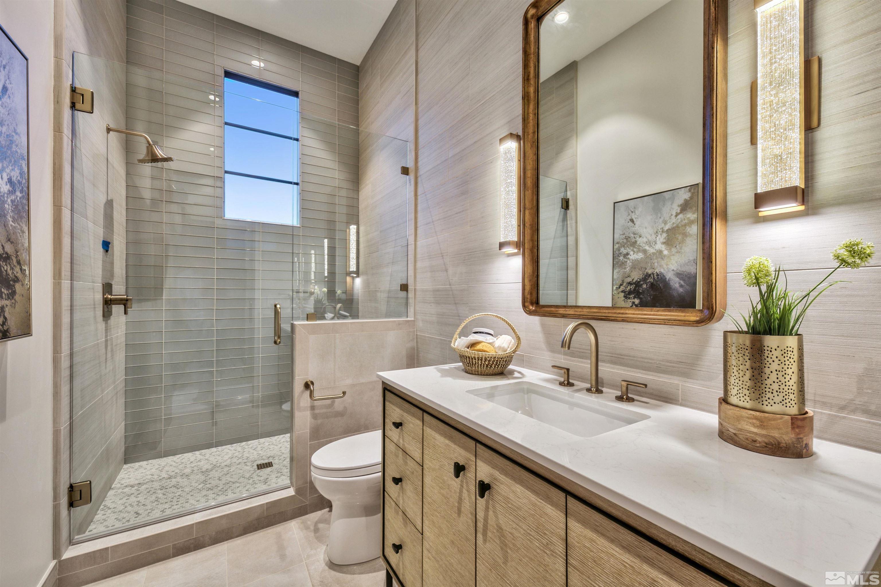 170 Hawken Road Reno, NV 89519 - Photo 17 of 26 a bathroom with a granite countertop sink a toilet a mirror and shower