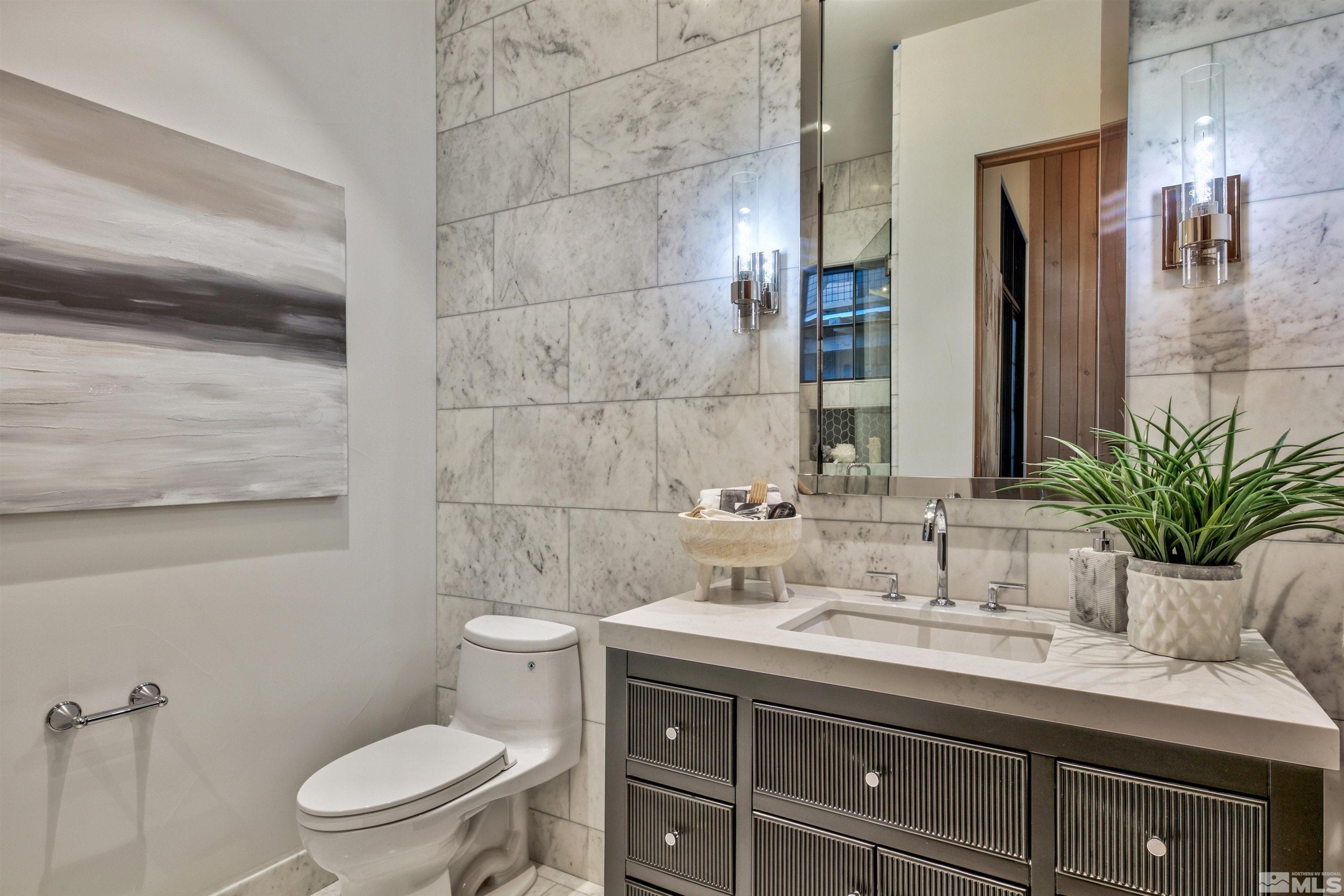 170 Hawken Road Reno, NV 89519 - Photo 19 of 26 a bathroom with a granite countertop sink a toilet a mirror and shower