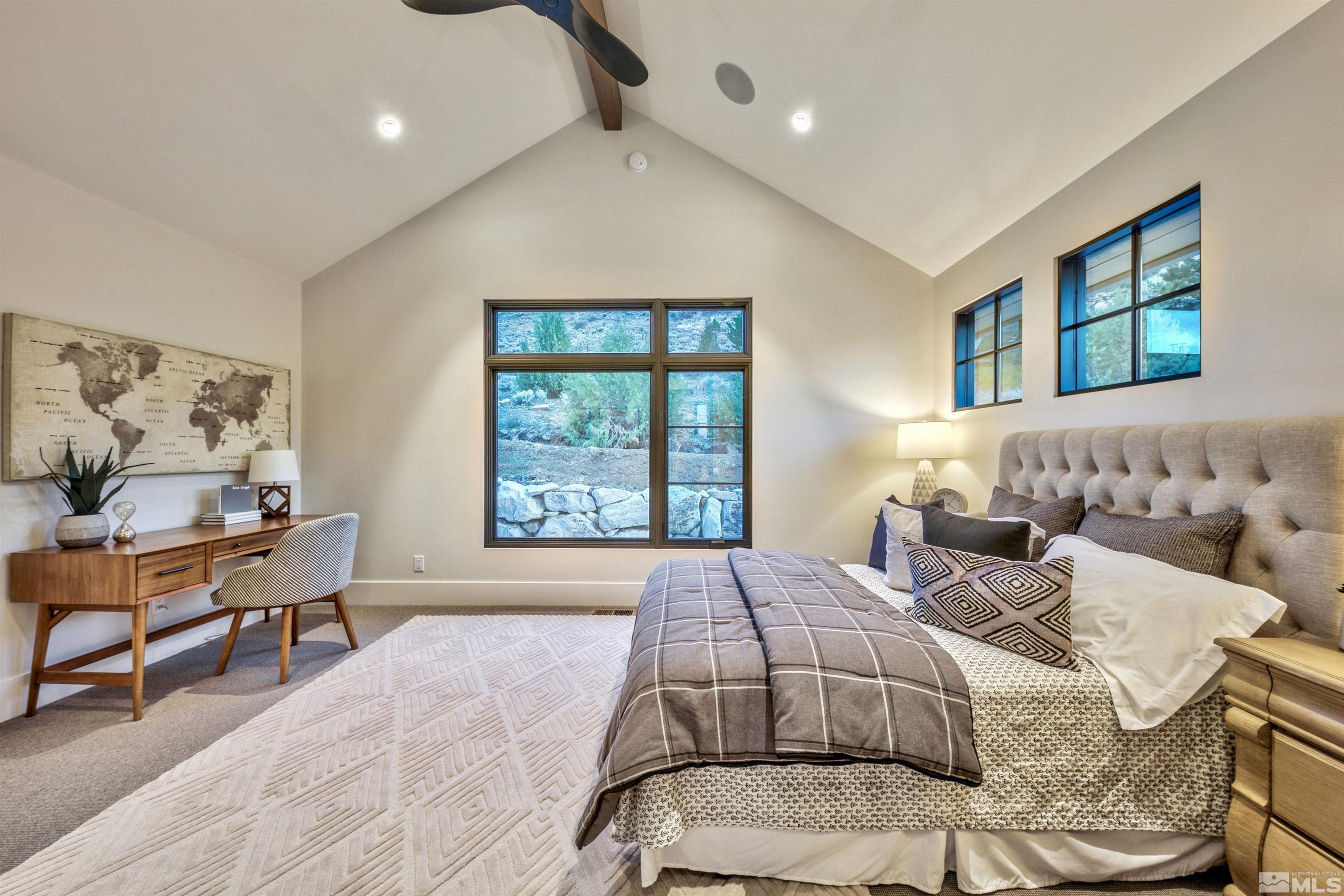170 Hawken Road Reno, NV 89519 - Photo 21 of 26 a spacious bedroom with a bed and a couch