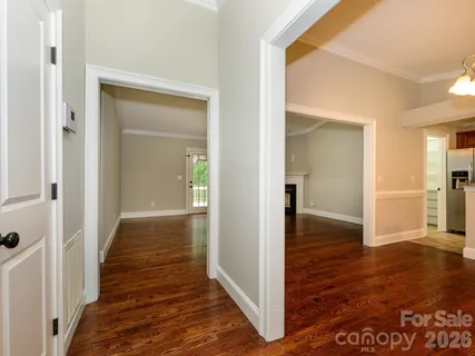 a view of a hallway with wooden floor
