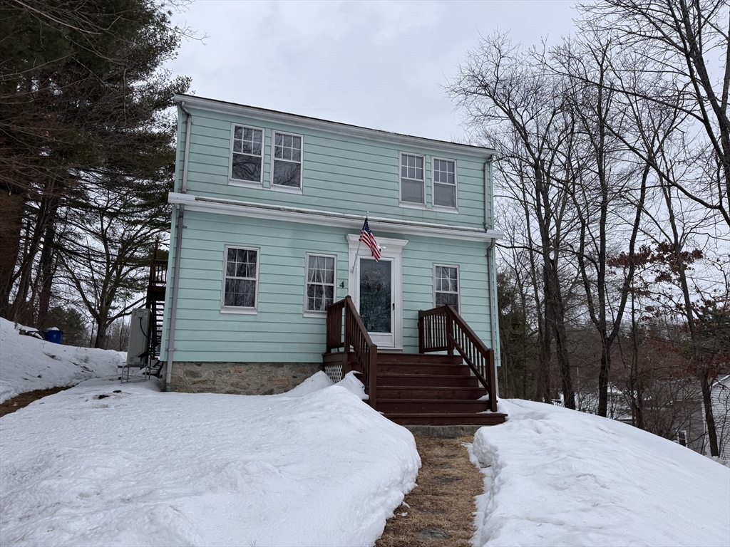4 James Street, Unit 2 Dudley, MA 01571 - Photo 1 of 15 a view of a house with a yard covered in snow