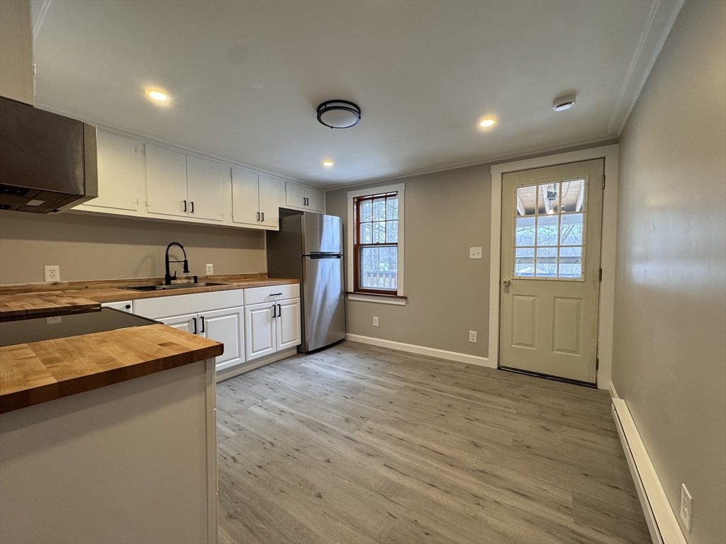 4 James Street, Unit 2 Dudley, MA 01571 - Photo 3 of 15 a kitchen with granite countertop a sink cabinets and stainless steel appliances