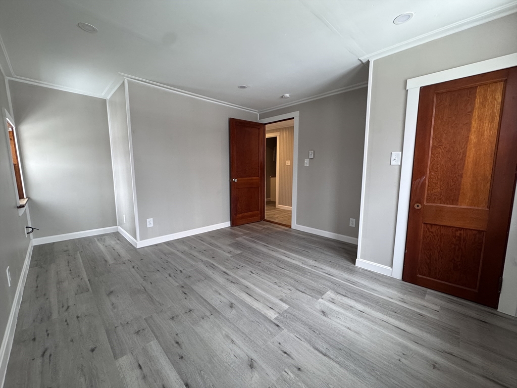 4 James Street, Unit 2 Dudley, MA 01571 - Photo 5 of 15 an empty room with wooden floor and closet