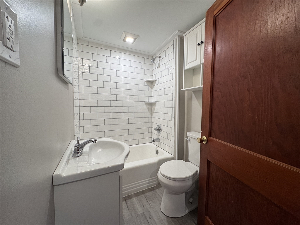 4 James Street, Unit 2 Dudley, MA 01571 - Photo 6 of 15 a bathroom with a toilet a sink and shower