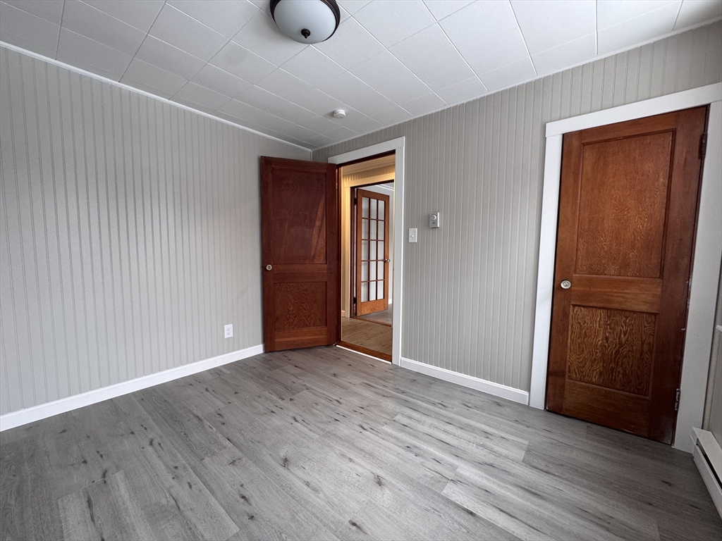 4 James Street, Unit 2 Dudley, MA 01571 - Photo 9 of 15 an empty room with wooden floor and closet