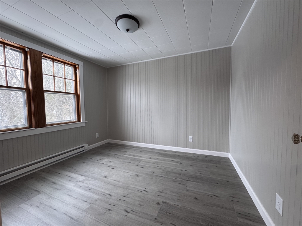 4 James Street, Unit 2 Dudley, MA 01571 - Photo 10 of 15 an empty room with wooden floor and windows