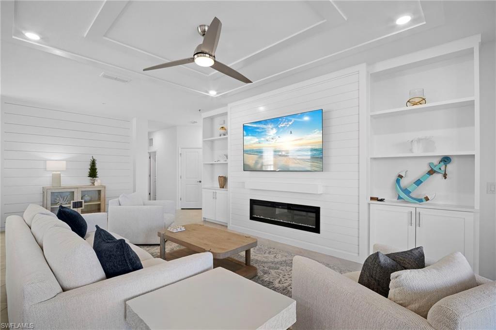 15194 Bluffton Lane, Unit 1422 Babcock Ranch, FL 33982 - Photo 12 of 35 a living room with furniture and a fireplace