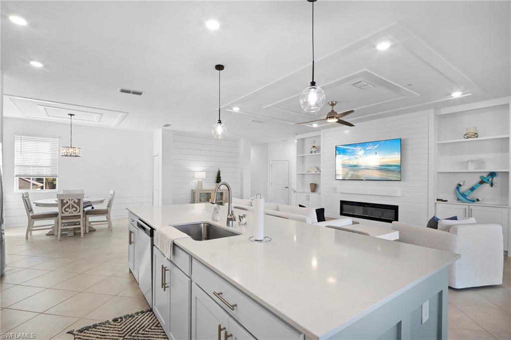 15194 Bluffton Lane, Unit 1422 Babcock Ranch, FL 33982 - Photo 17 of 35 a large kitchen with kitchen island a sink a counter space and a view of living room