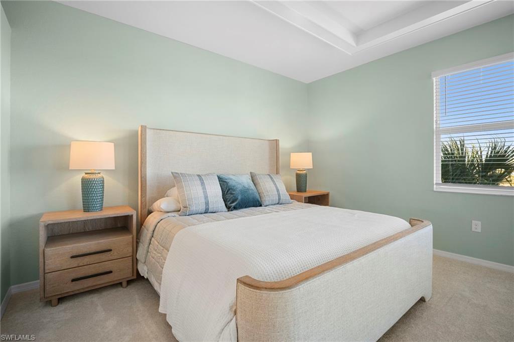 15194 Bluffton Lane, Unit 1422 Babcock Ranch, FL 33982 - Photo 24 of 35 a bedroom with a bed and a night stand