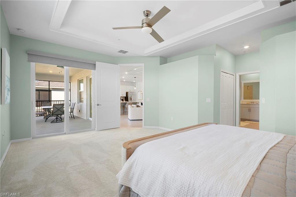 15194 Bluffton Lane, Unit 1422 Babcock Ranch, FL 33982 - Photo 25 of 35 a spacious bedroom with a bed a table and chairs