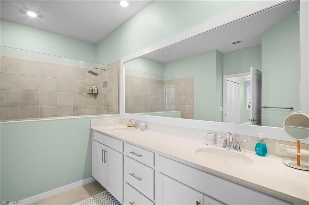 15194 Bluffton Lane, Unit 1422 Babcock Ranch, FL 33982 - Photo 27 of 35 a bathroom with a granite countertop sink and a mirror