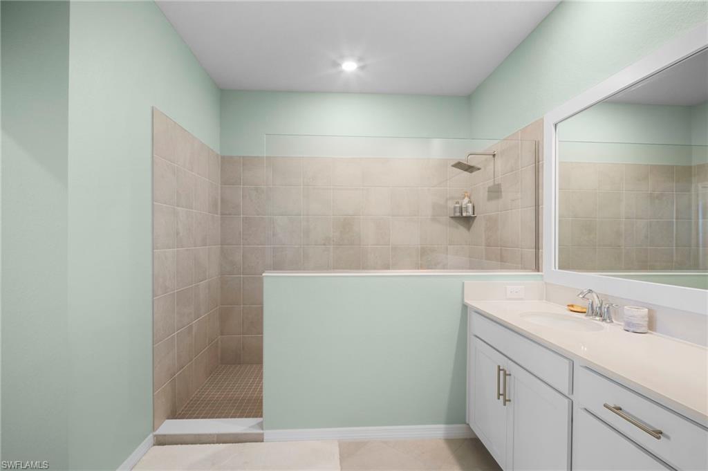 15194 Bluffton Lane, Unit 1422 Babcock Ranch, FL 33982 - Photo 28 of 35 a bathroom with a sink and a mirror