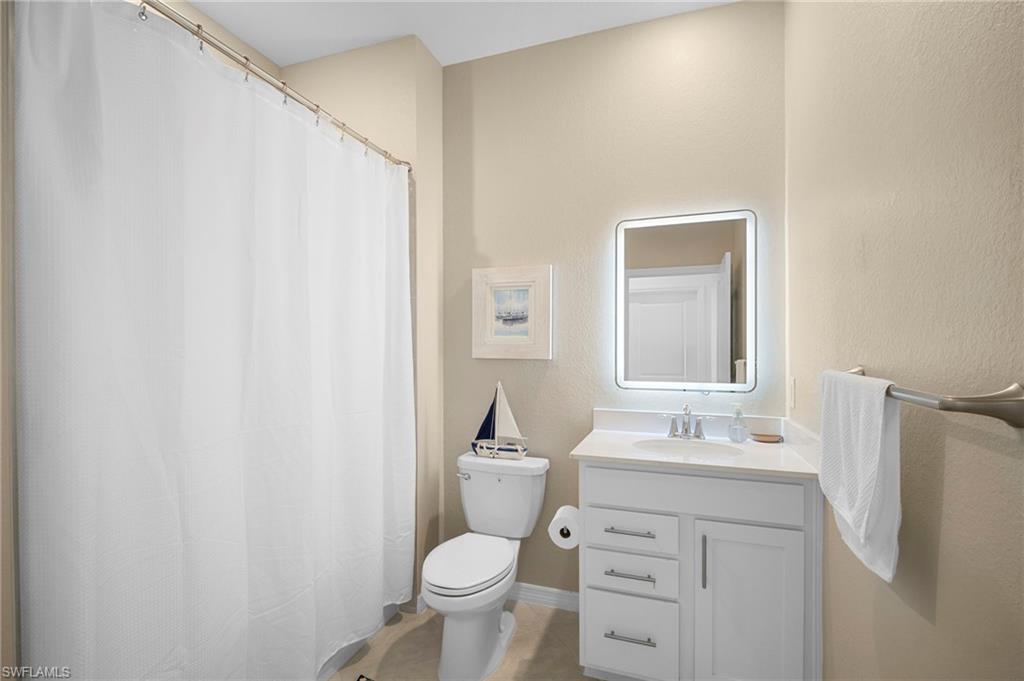 15194 Bluffton Lane, Unit 1422 Babcock Ranch, FL 33982 - Photo 29 of 35 a bathroom with a sink toilet and mirror