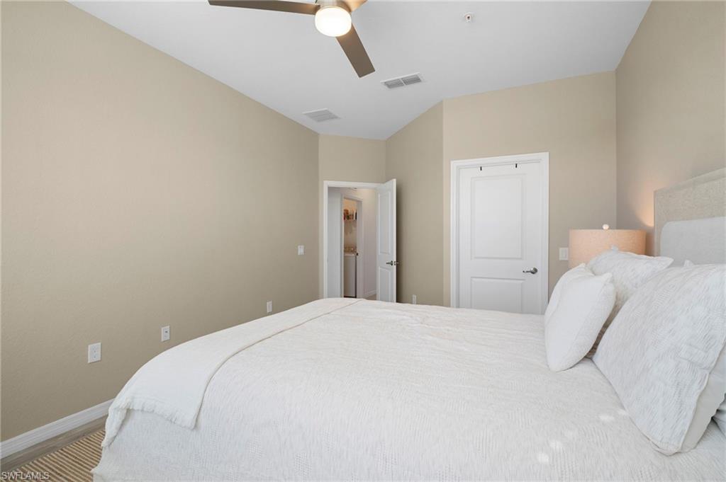 15194 Bluffton Lane, Unit 1422 Babcock Ranch, FL 33982 - Photo 32 of 35 a bedroom with a bed and painting on the wall