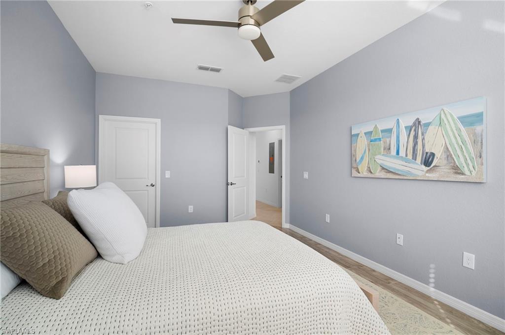 15194 Bluffton Lane, Unit 1422 Babcock Ranch, FL 33982 - Photo 34 of 35 a bedroom with a bed and painting on the wall