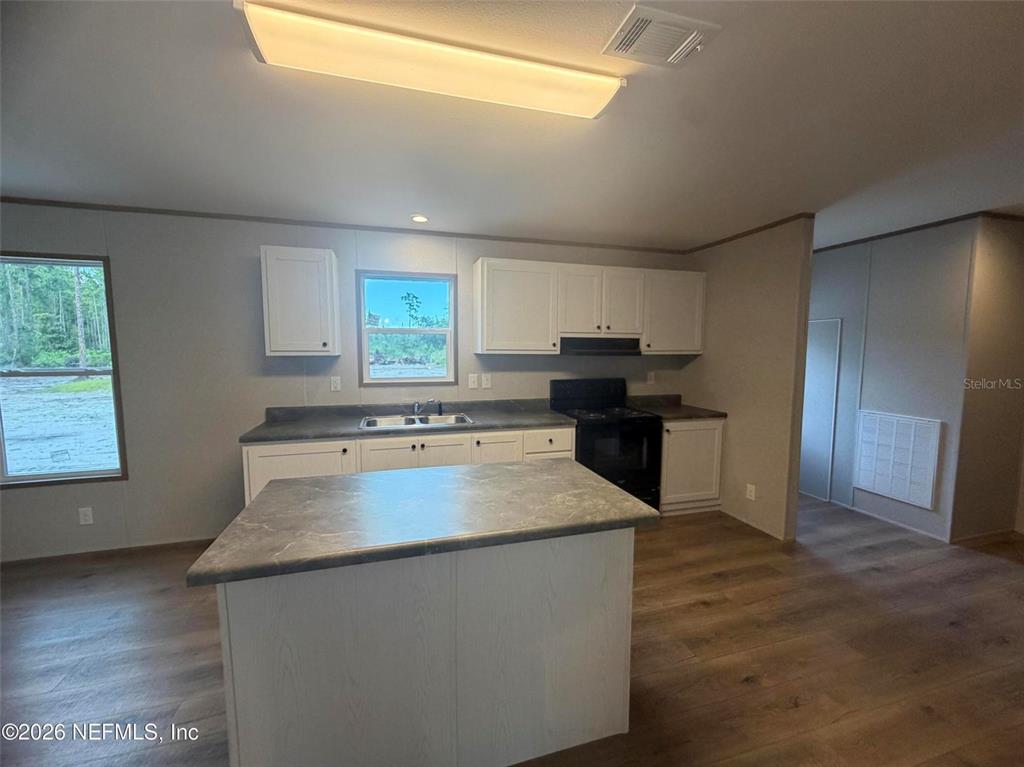 114 Nutmeg Trail Interlachen, FL 32148 - Photo 13 of 33 a kitchen with stainless steel appliances granite countertop a sink stove and refrigerator