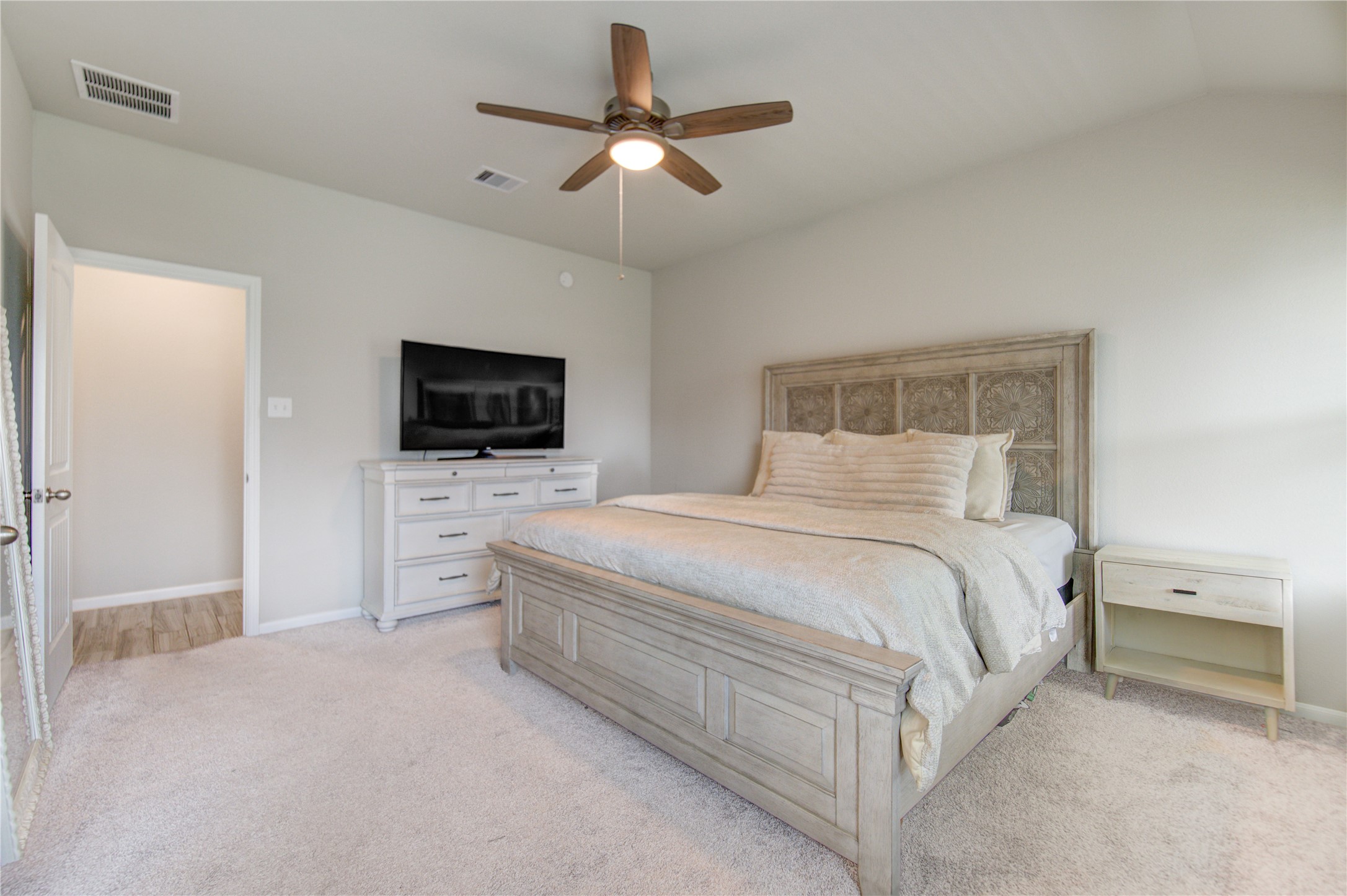 5011 Yellow Rays Trail Katy, TX 77493 - Photo 22 of 47 a bedroom with a bed a tv and a fireplace