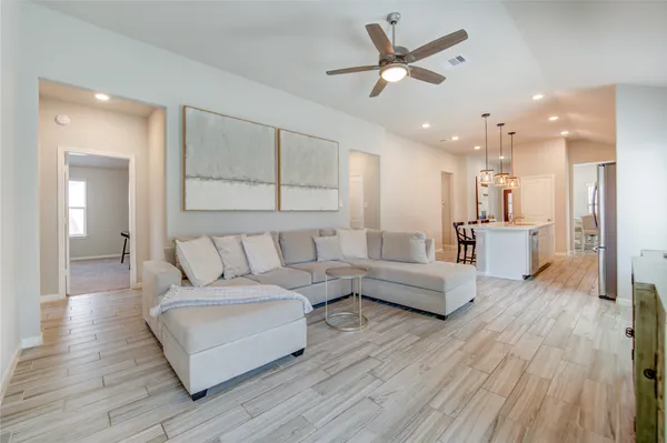 a living room with furniture and wooden floor