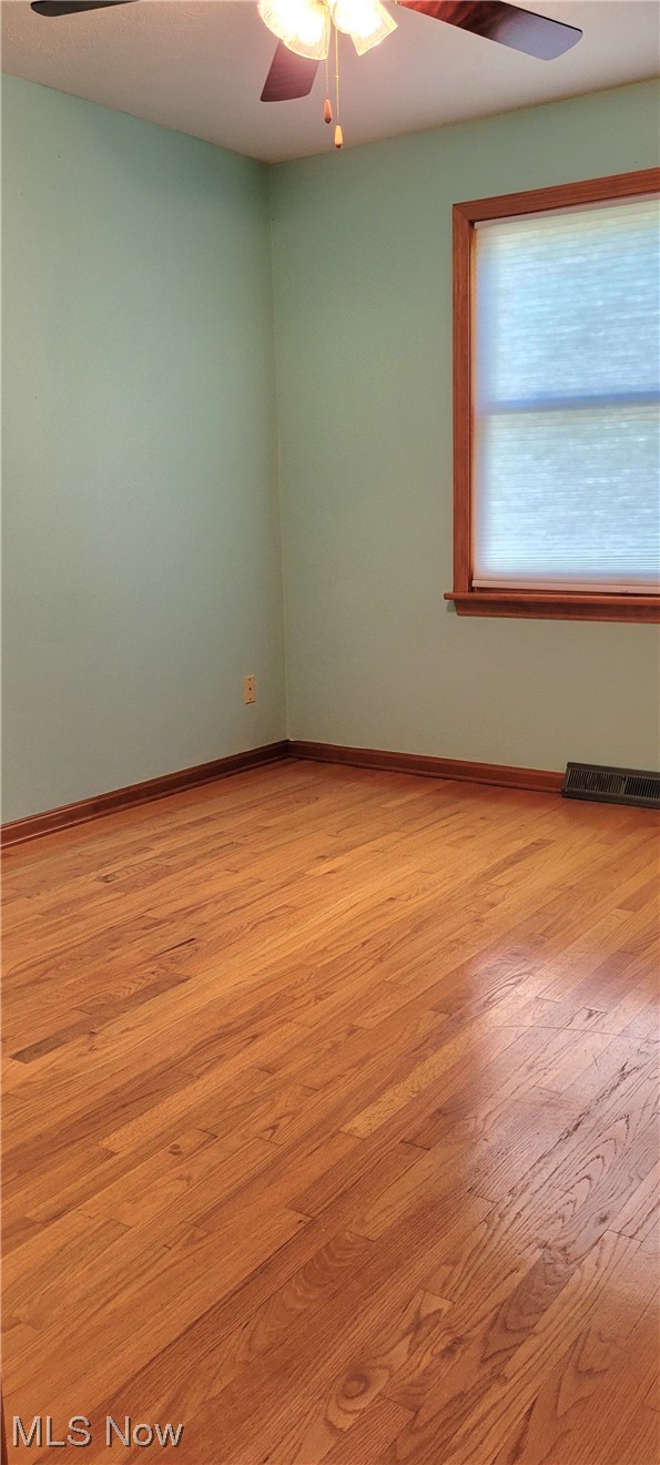 6015 Ford Road Elyria, OH 44035 - Photo 19 of 32 Unfurnished room with ceiling fan and light hardwood floors