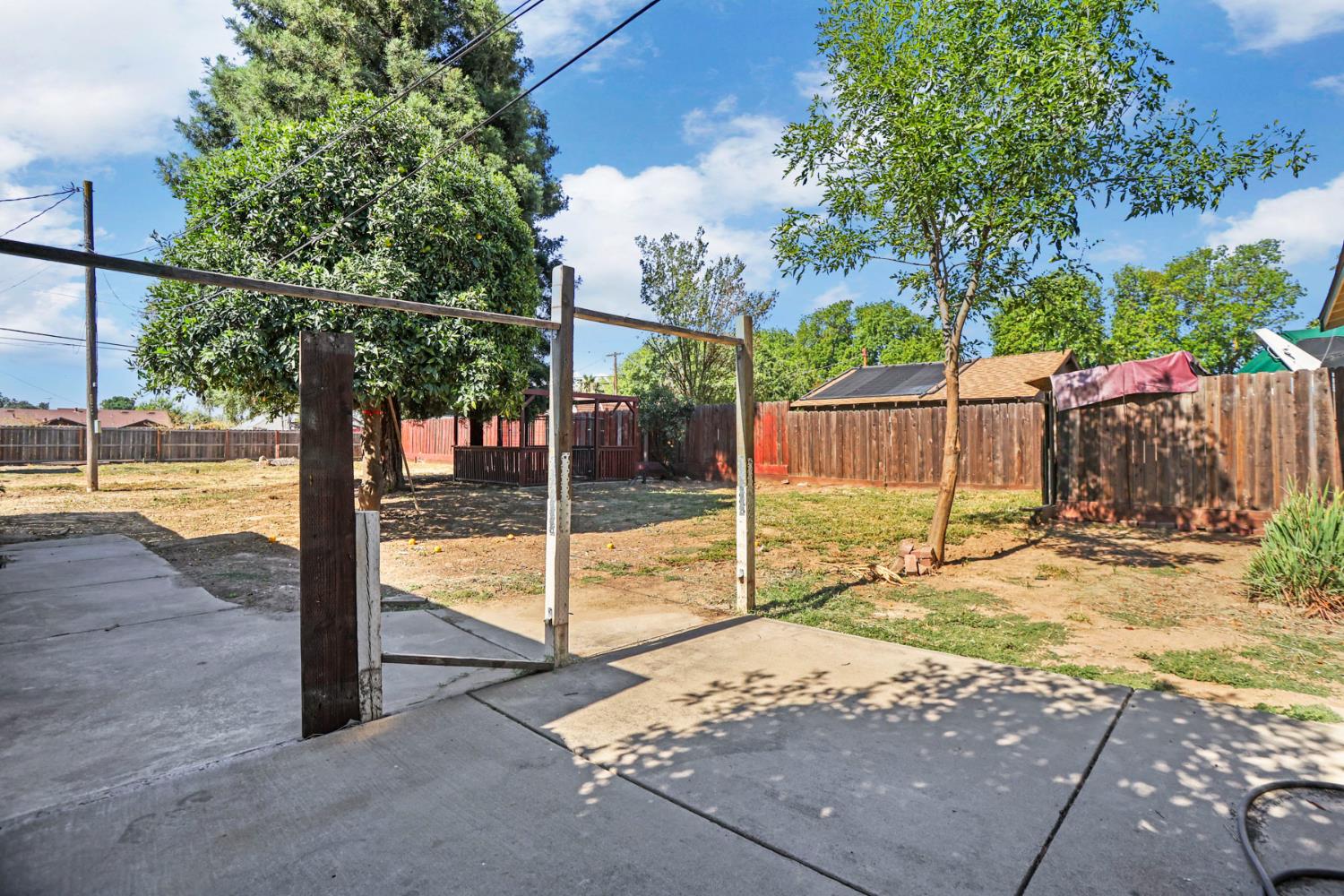 916 Elm Avenue Modesto, CA 95351 - Photo 27 of 52 28. Backyard patio view The backyard opens up with patio space, mature trees, and room to imagine gatherings, gardening, pets, projects, or all of the above.