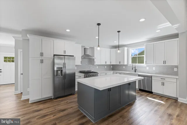 a kitchen with a sink stove and refrigerator