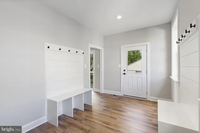 a view of an entryway with wooden floor
