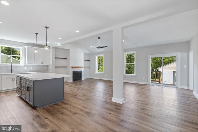 a large kitchen with a table and chairs