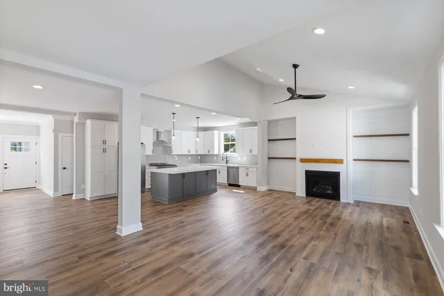 a view of kitchen with sink microwave and refrigerator