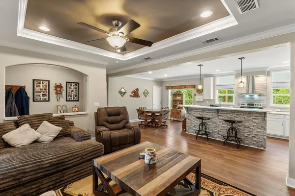 a living room with furniture and wooden floor